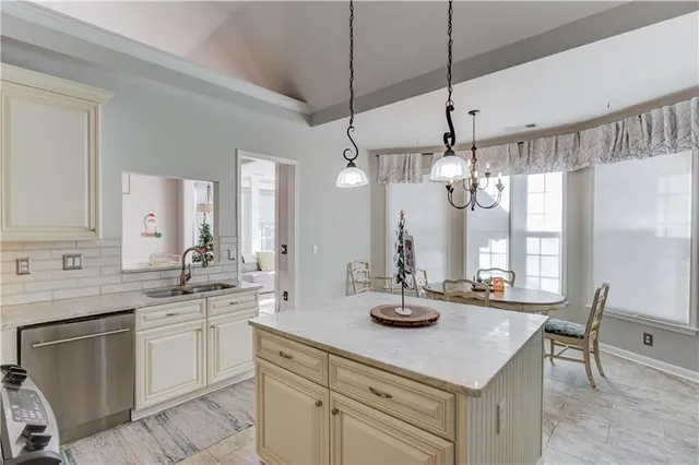 a kitchen with sink a center island and cabinets