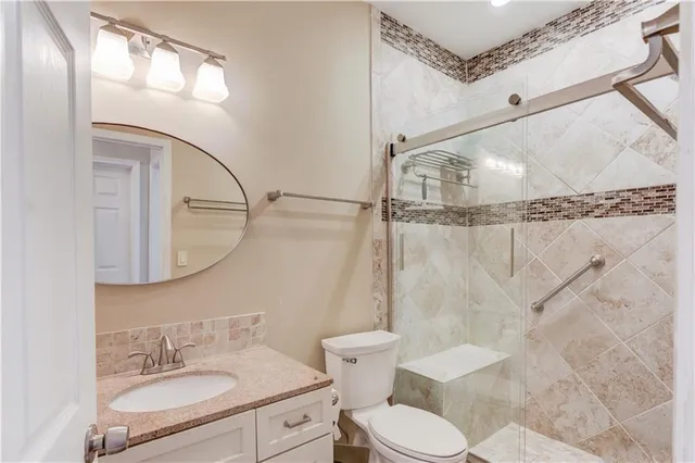 a bathroom with a sink toilet and shower