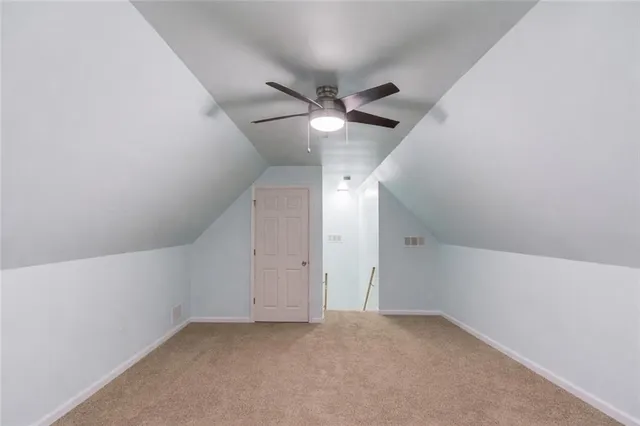 an empty room with a ceiling fan and a projector