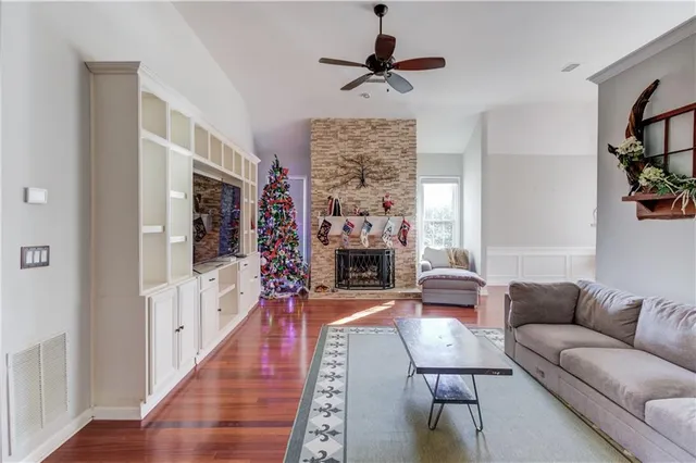 a living room with furniture a flat screen tv and a fireplace
