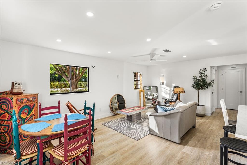 27682 Imperial River Road, Unit CH1 Bonita Springs, FL 34134 - Photo 2 of 24 a living room with dining room and wooden floor