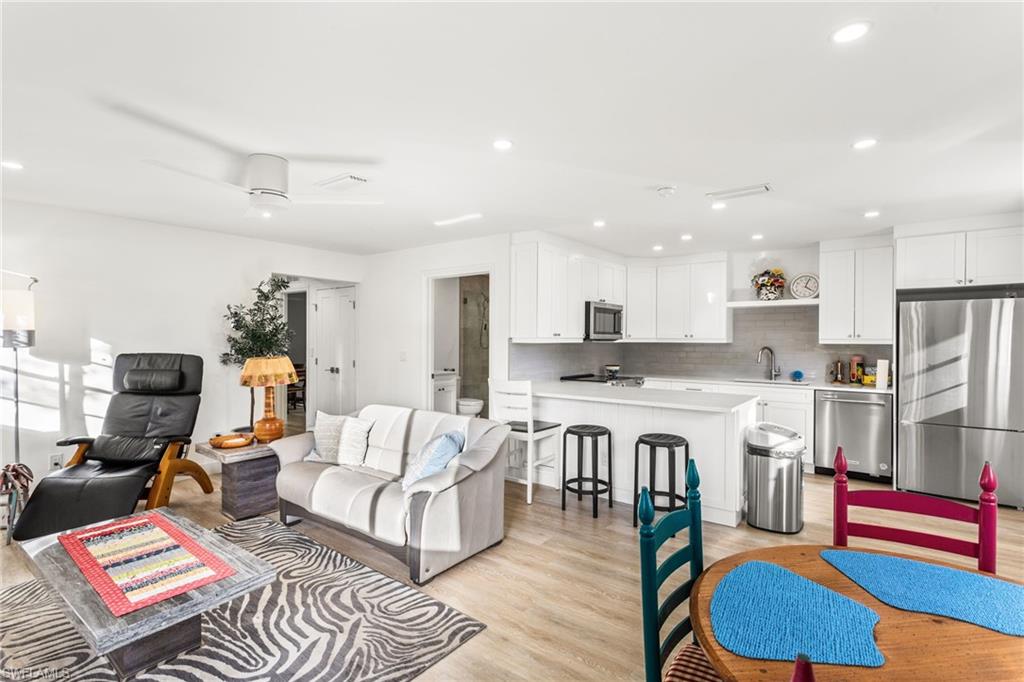 27682 Imperial River Road, Unit CH1 Bonita Springs, FL 34134 - Photo 4 of 24 a living room with kitchen island furniture and a kitchen view