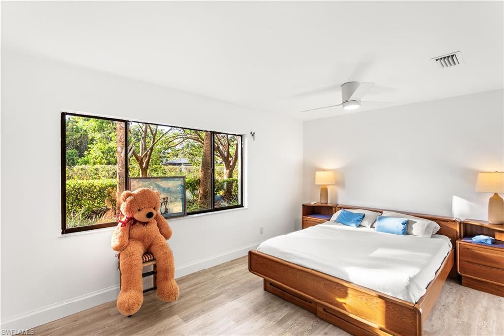 27682 Imperial River Road, Unit CH1 Bonita Springs, FL 34134 - Photo 9 of 24 a bedroom with a bed and a large window