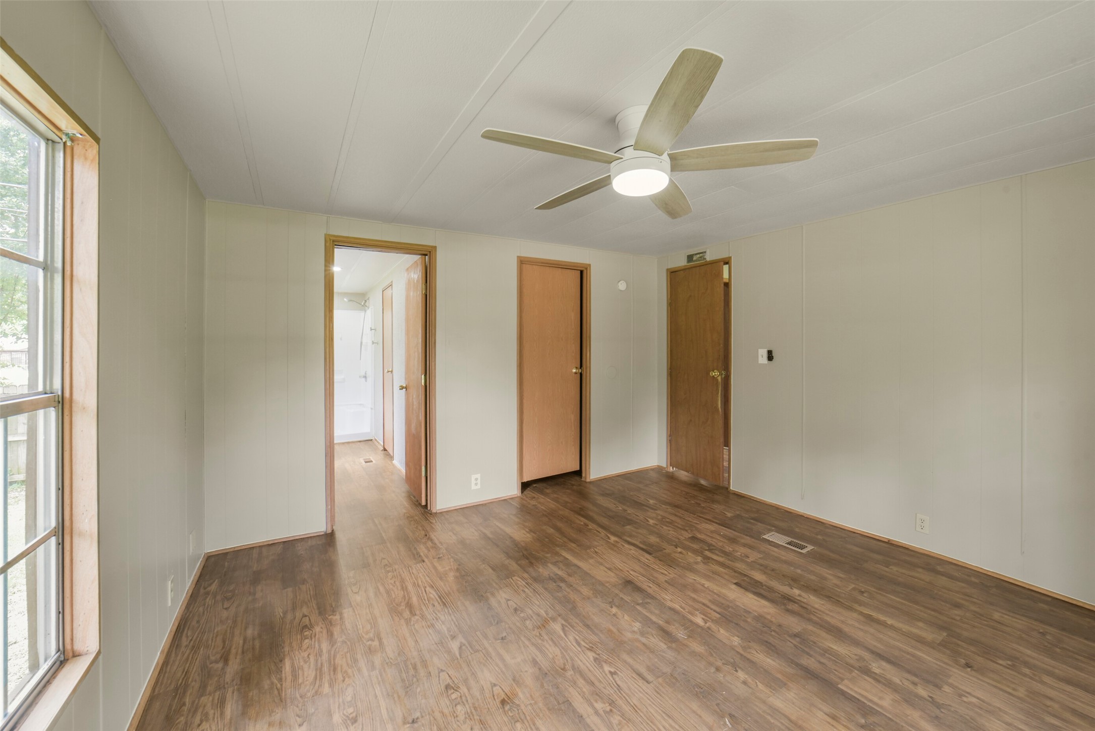 11023 Forrest Valley Drive Houston, TX 77065 - Photo 24 of 47 a view of an empty room with wooden floor and a window