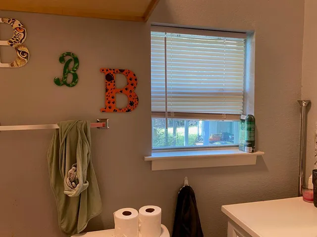 a bathroom with a window and a shower