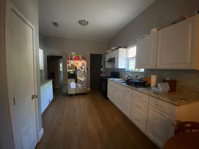 a kitchen with stainless steel appliances granite countertop a refrigerator and a sink