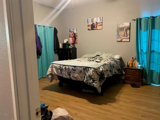 a bedroom with a bed table and a large closet