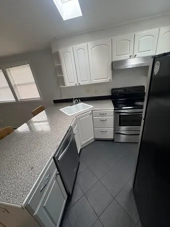 a stove top oven sitting inside of a kitchen