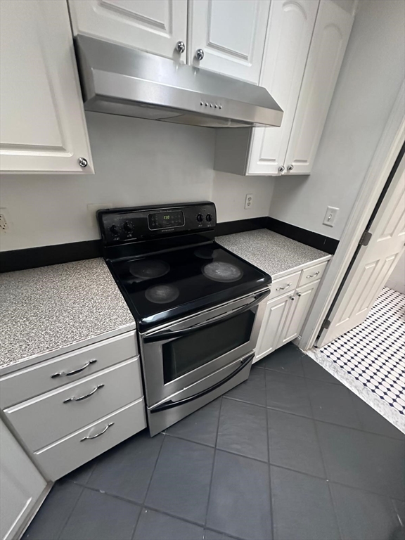 1295 Millbury Street, Unit B Worcester, MA 01607 - Photo 13 of 28 a stove top oven sitting inside of a kitchen