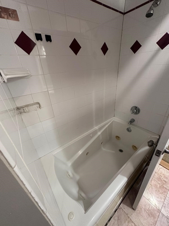 1295 Millbury Street, Unit B Worcester, MA 01607 - Photo 18 of 28 a bathroom with a bath tub and shower