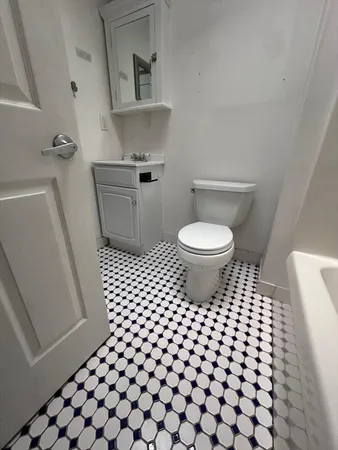 a bathroom with a sink toilet and mirror