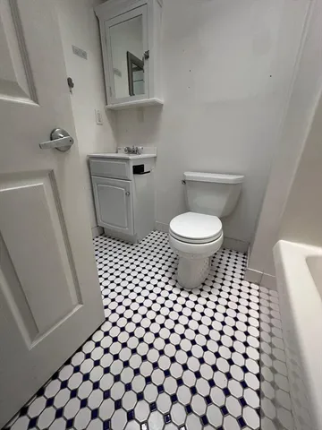 a bathroom with a sink toilet and mirror