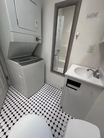 a bathroom with a sink toilet and a mirror