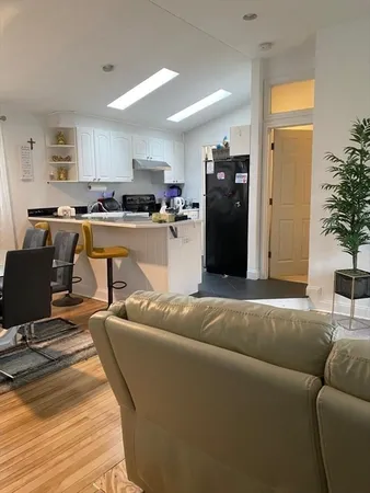 a bedroom with a bed plant and window