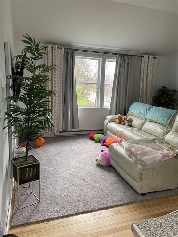1295 Millbury Street, Unit B Worcester, MA 01607 - Photo 27 of 28 a bedroom with a bed plant and window