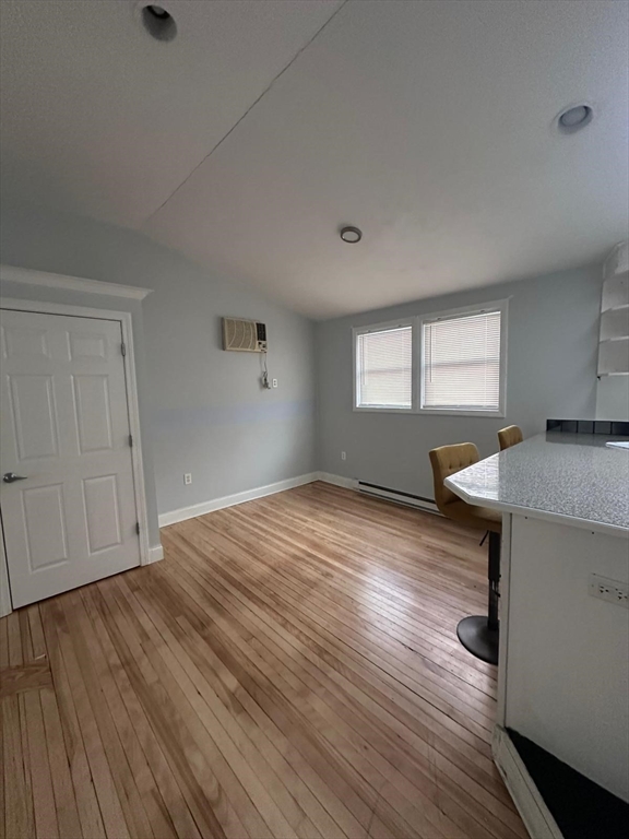 1295 Millbury Street, Unit B Worcester, MA 01607 - Photo 6 of 28 an empty room with wooden floor and windows