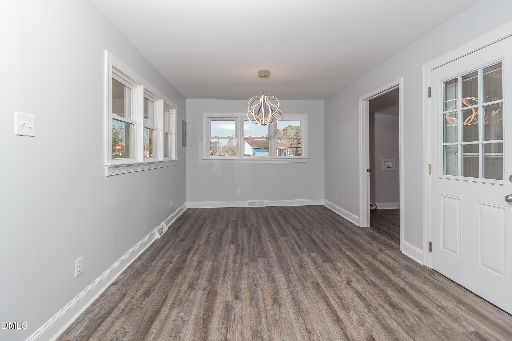 107 East New Hope Road Goldsboro, NC 27534 - Photo 11 of 33 an empty room with wooden floor exposed radiator and windows