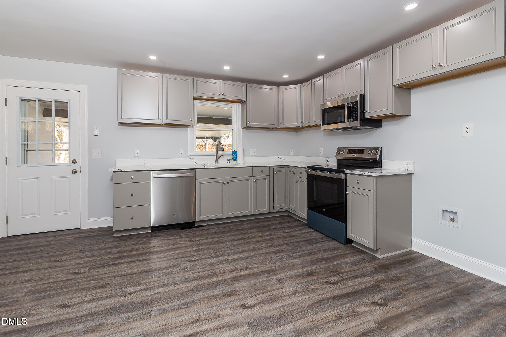 107 East New Hope Road Goldsboro, NC 27534 - Photo 7 of 33 a kitchen with stainless steel appliances granite countertop a stove top oven sink and cabinets