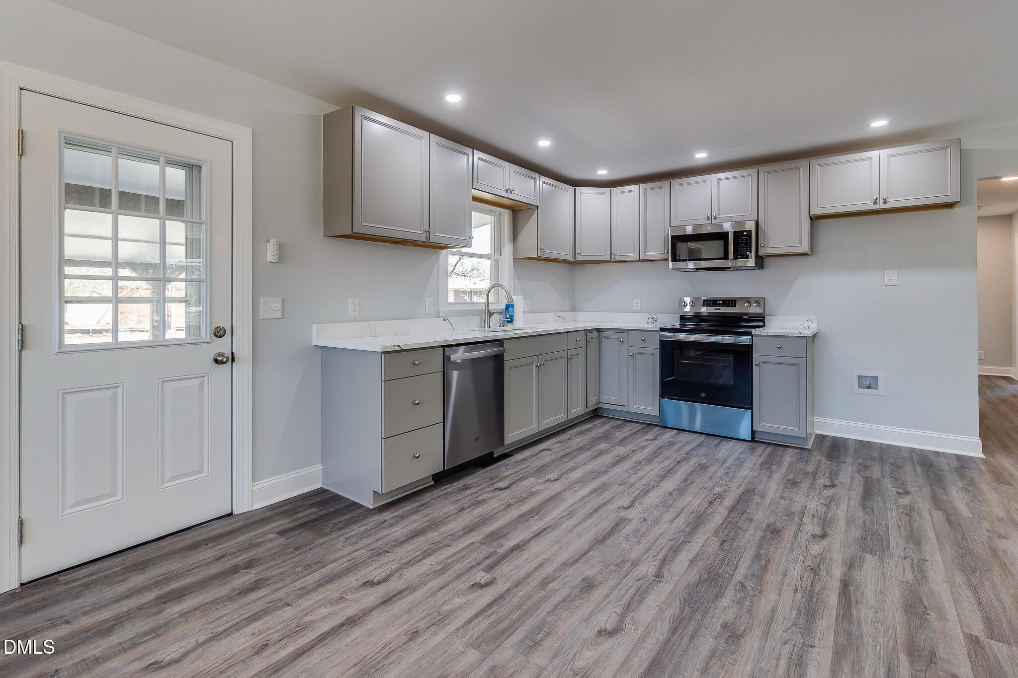 107 East New Hope Road Goldsboro, NC 27534 - Photo 9 of 33 a kitchen with stainless steel appliances granite countertop a stove top oven a sink dishwasher and a refrigerator with wooden floors