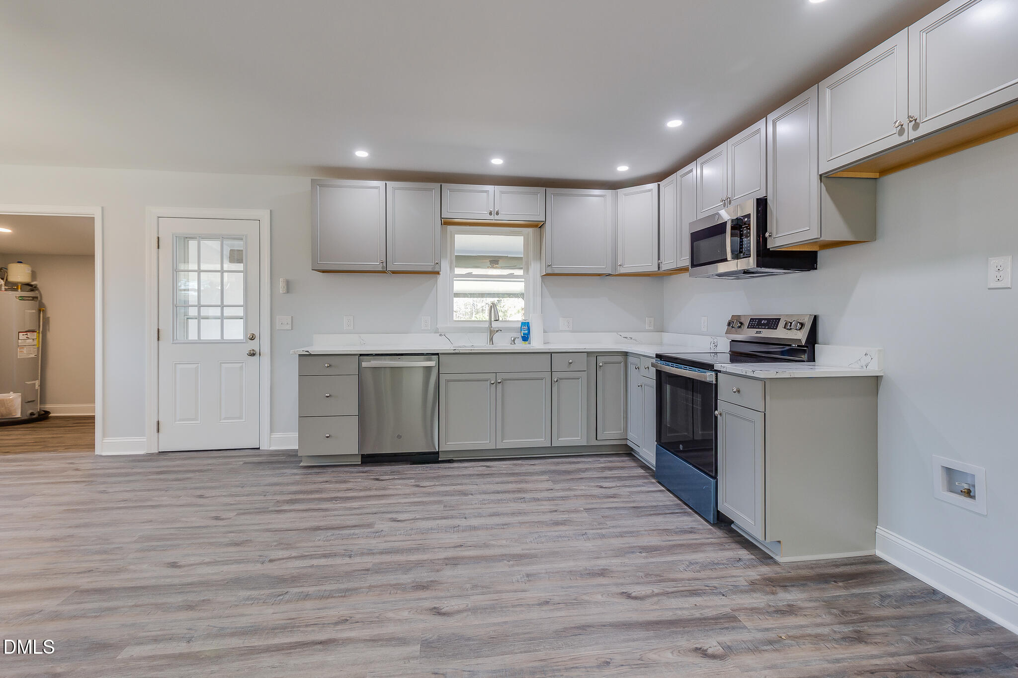 107 East New Hope Road Goldsboro, NC 27534 - Photo 10 of 33 a kitchen with stainless steel appliances granite countertop a stove top oven a sink dishwasher and a refrigerator with wooden floor