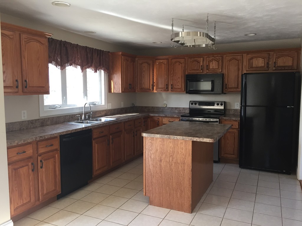21 Winifreds Way Rutland, MA 01543 - Photo 2 of 15 a kitchen with stainless steel appliances granite countertop a refrigerator a sink a stove a microwave and island