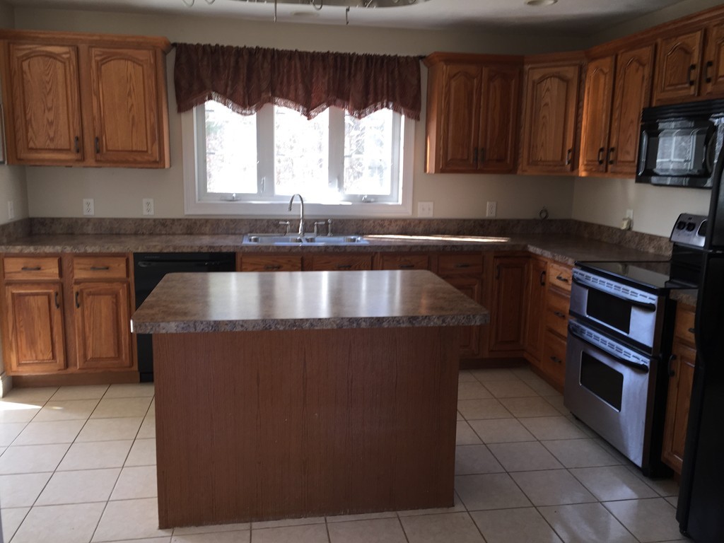 21 Winifreds Way Rutland, MA 01543 - Photo 3 of 15 a kitchen with stainless steel appliances granite countertop a stove a sink and a microwave