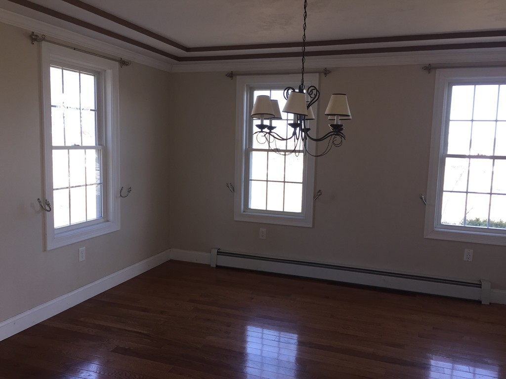 21 Winifreds Way Rutland, MA 01543 - Photo 6 of 15 a view of a room with wooden floors and chandelier