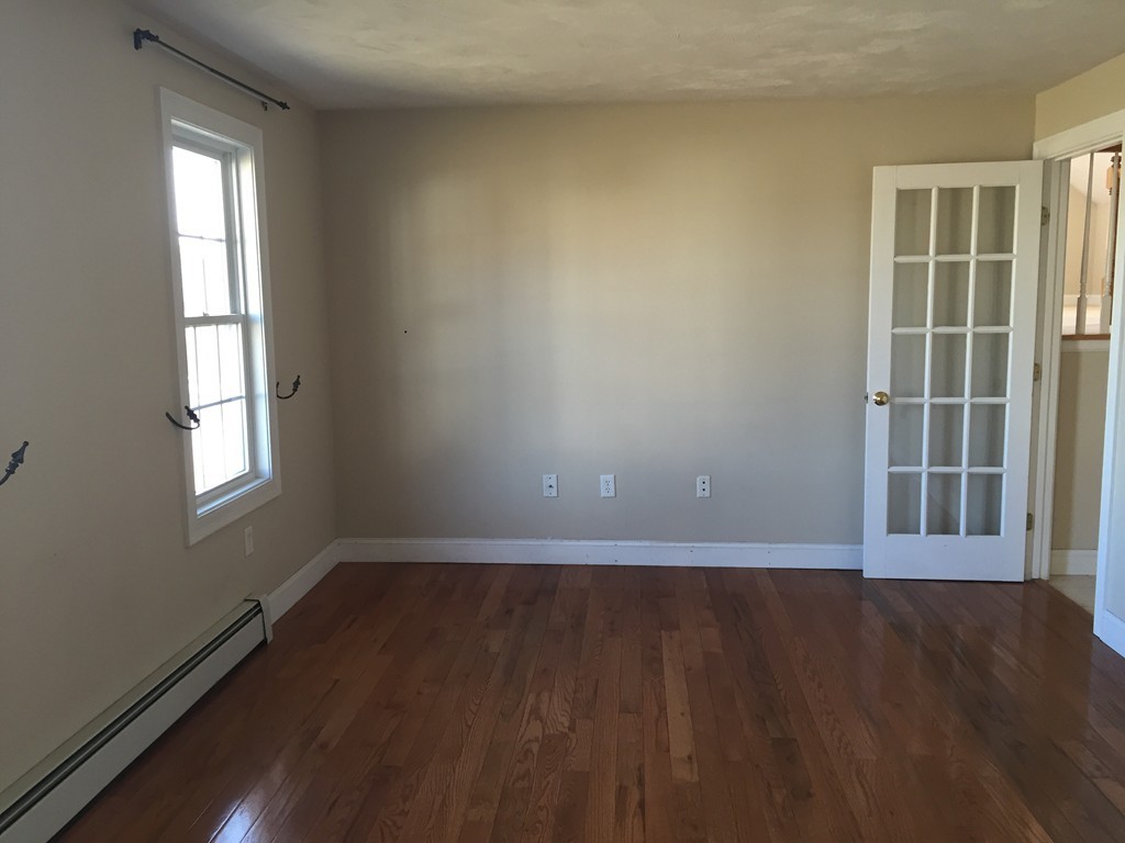21 Winifreds Way Rutland, MA 01543 - Photo 10 of 15 a view of an empty room with wooden floor and a window