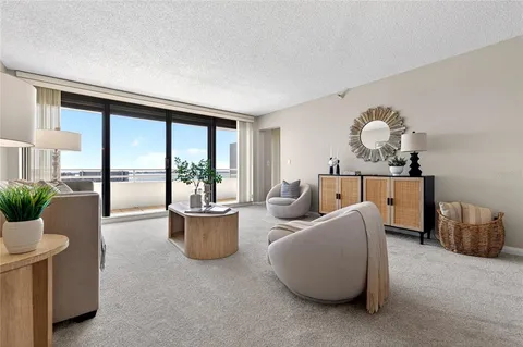 a living room with furniture and a potted plant