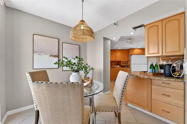 a view of a dining room with furniture and chandelier
