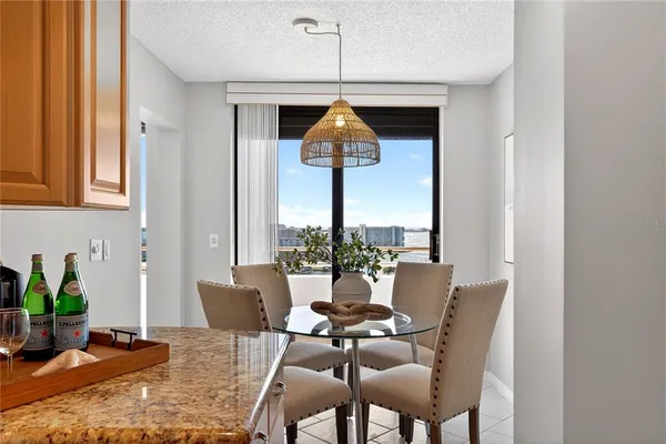a dining room with furniture and wooden floor