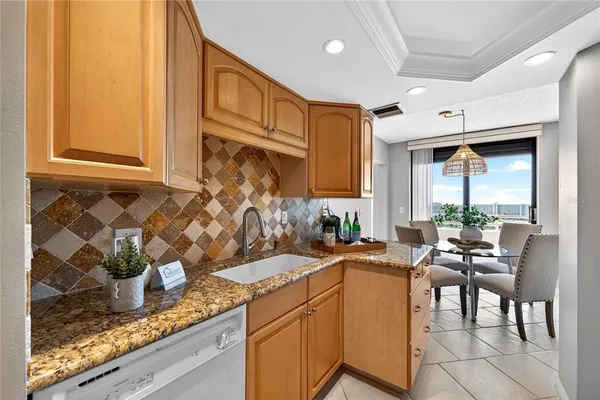 a kitchen with granite countertop lots of counter top space and living room