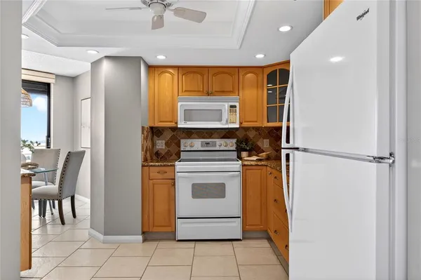 a kitchen with a stove refrigerator and microwave