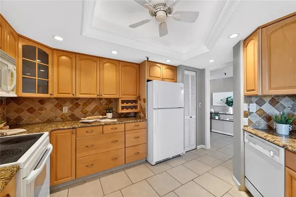 a kitchen with a refrigerator a sink and dishwasher with a large window