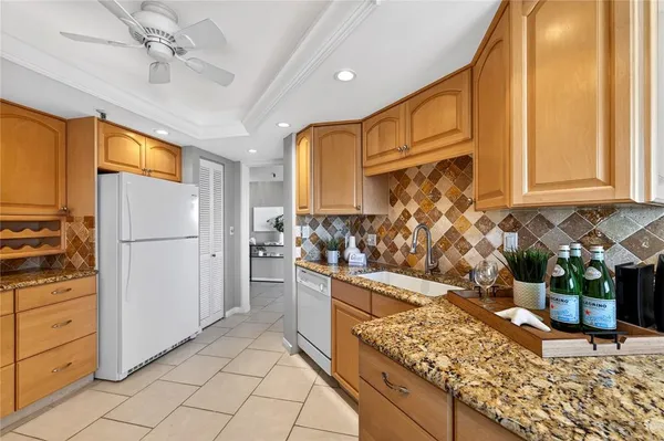 a kitchen with stainless steel appliances granite countertop a refrigerator and a stove