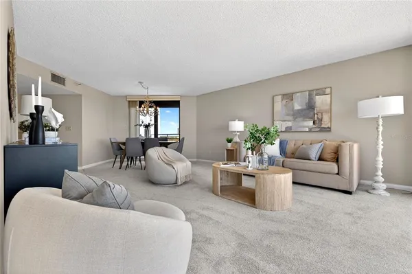 a living room with furniture and a potted plant