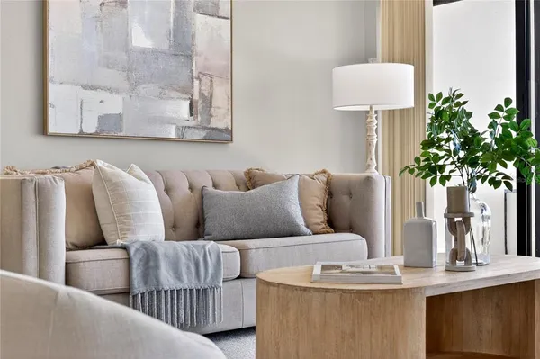 a living room with furniture large window and lamp