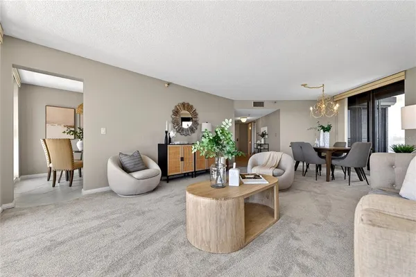 a living room with furniture and large windows