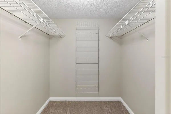 a view of living room filled with furniture and a mirror