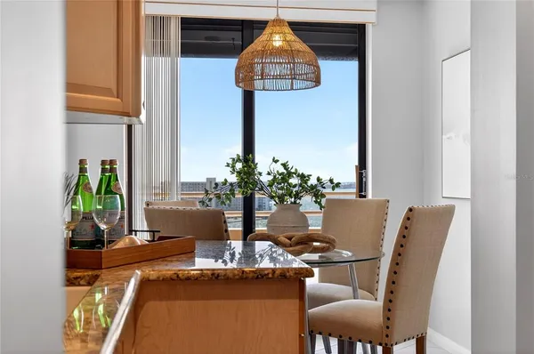 a table room with chairs and potted plant