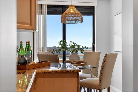 a table room with chairs and potted plant