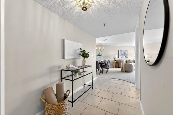 a living room with furniture a rug and a mirror