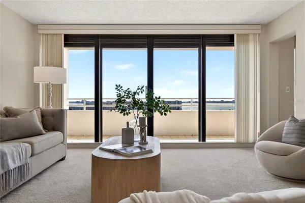 a living room with furniture and a potted plant