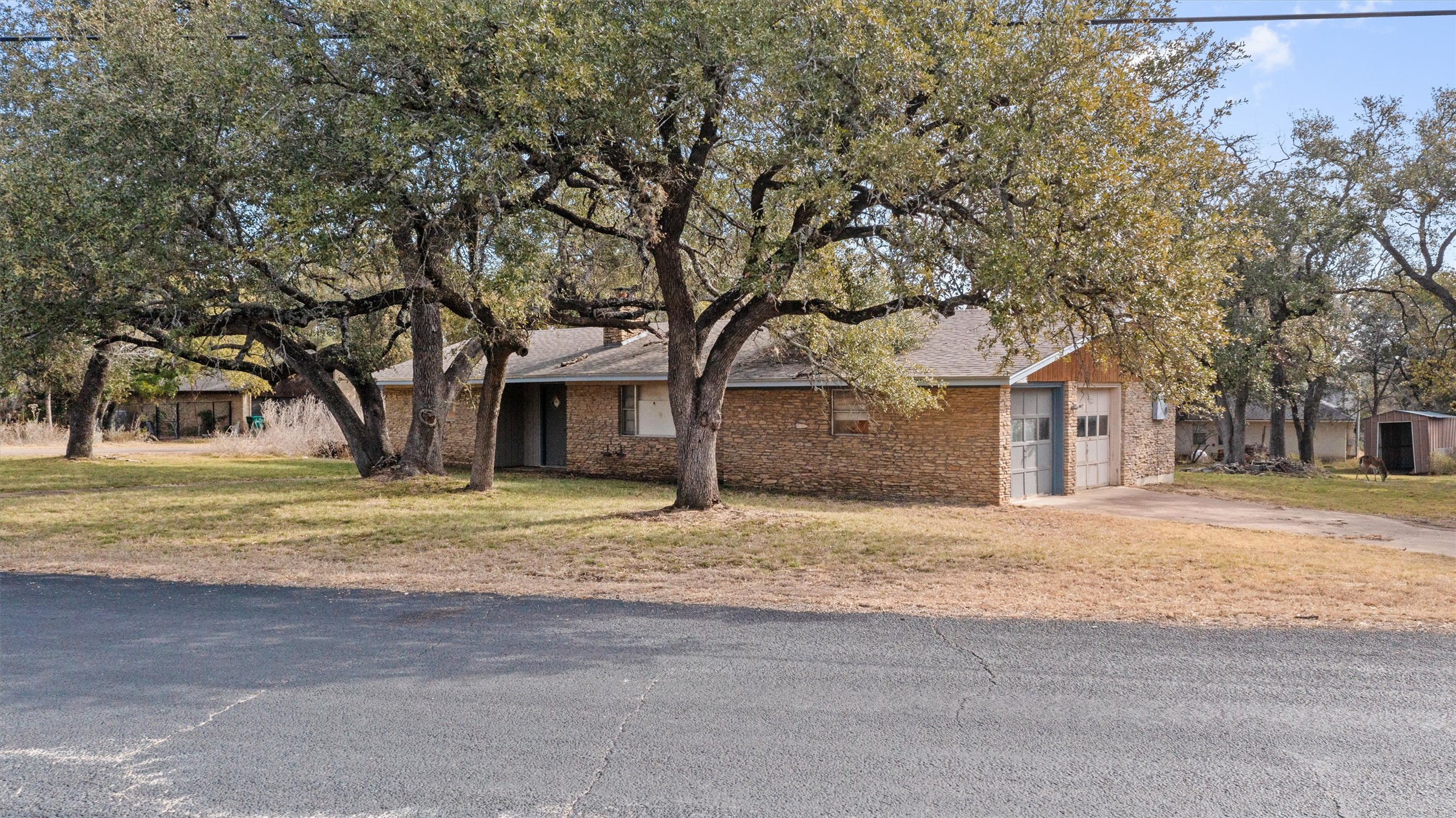 43 Morgan's Point Boulevard Belton, TX 76513 - Photo 1 of 1 View of front of property featuring brick siding, driveway, an attached garage, and a front lawn