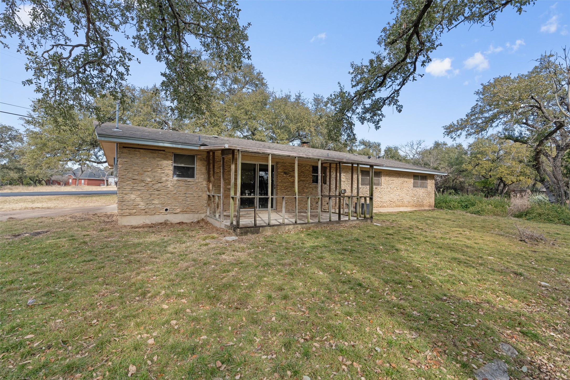 43 Morgan's Point Boulevard Belton, TX 76513 - Photo 23 of 28 Rear view of house with brick siding, a yard, and a patio area