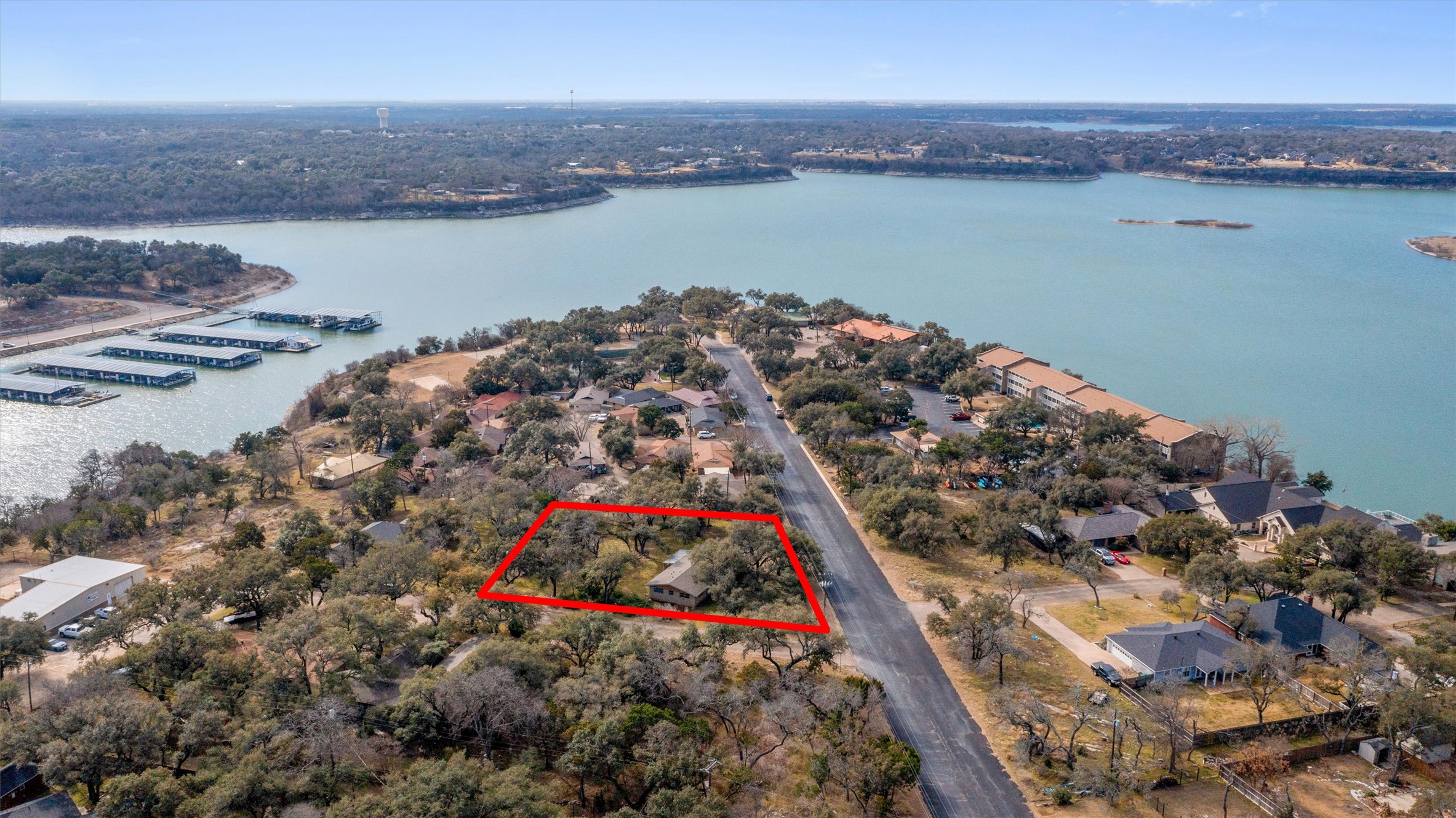 43 Morgan's Point Boulevard Belton, TX 76513 - Photo 2 of 28 Aerial view of property's location with a large body of water, property parcel outlined, and nearby suburban area