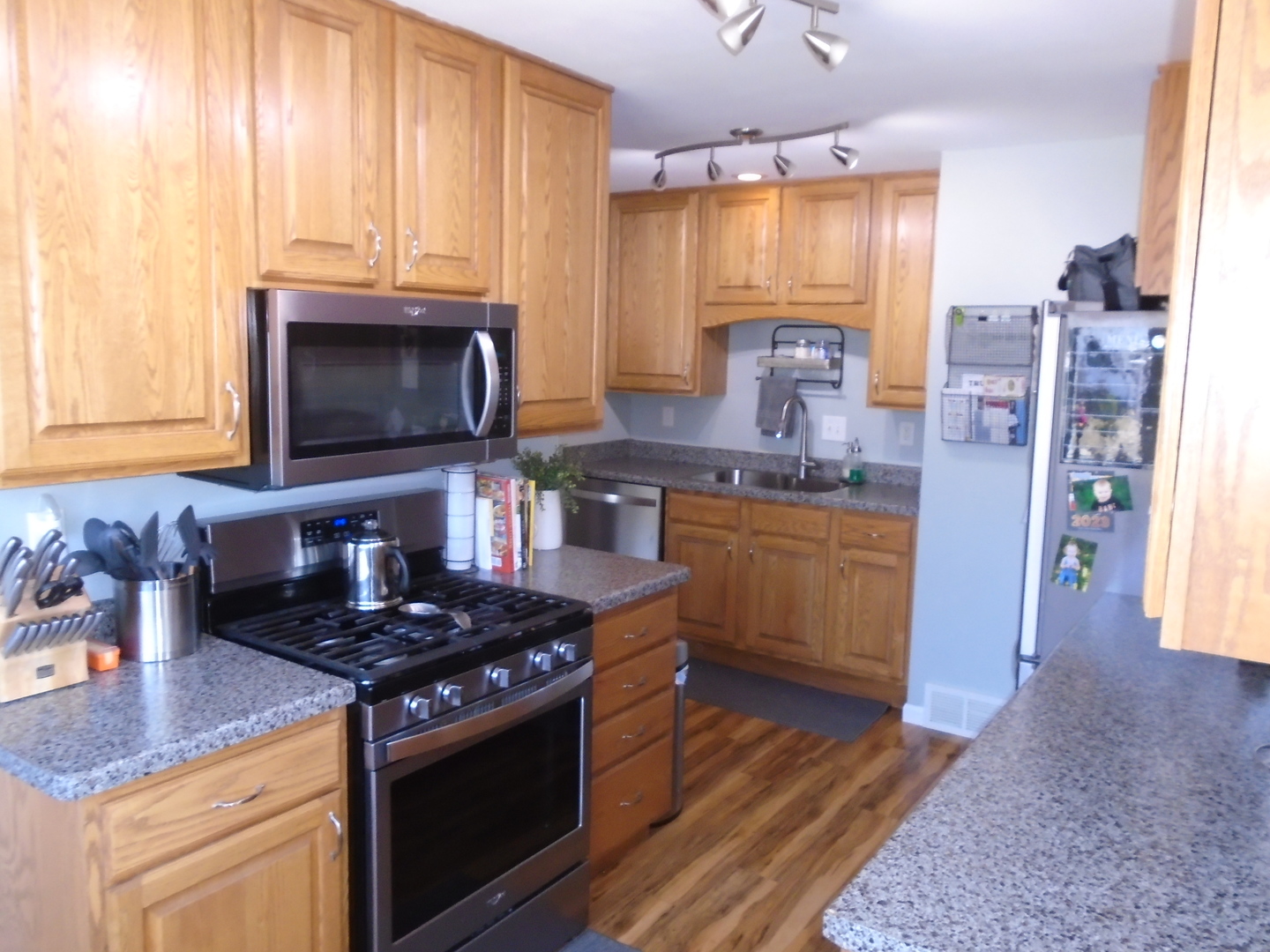 1221 7th Avenue Rochelle, IL 61068 - Photo 8 of 20 a kitchen with stainless steel appliances granite countertop a stove a sink and a microwave