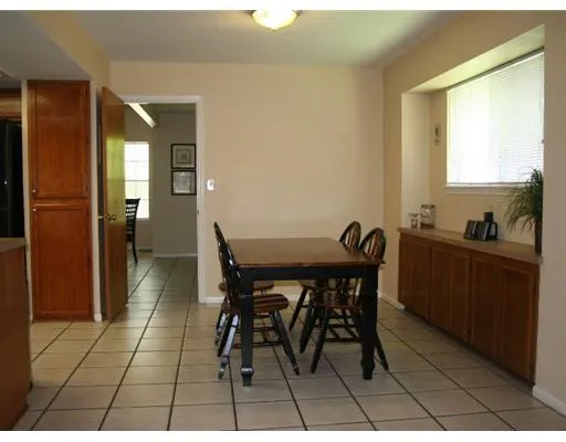 a view of a dining room with furniture and a window