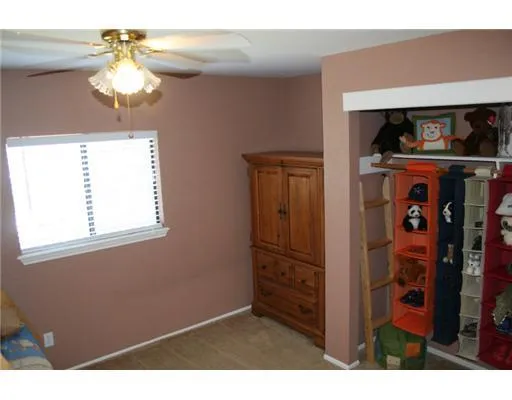 a bedroom with a bed and a mirror on dresser