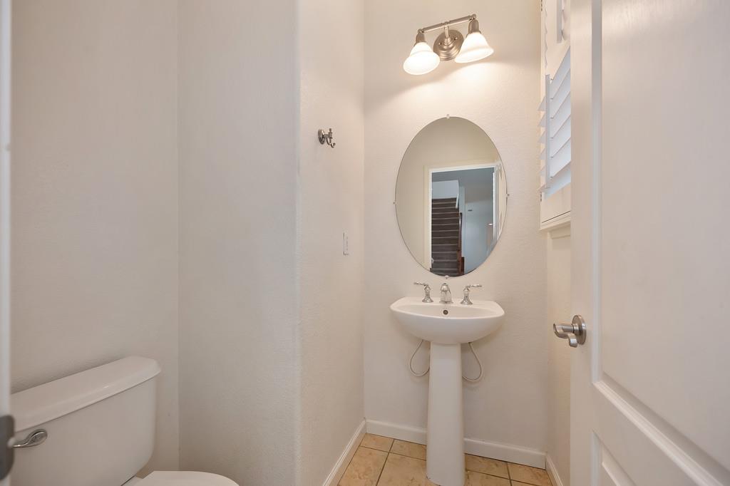 3505 Husch Way Rancho Cordova, CA 95670 - Photo 18 of 37 a bathroom with a sink mirror and toilet